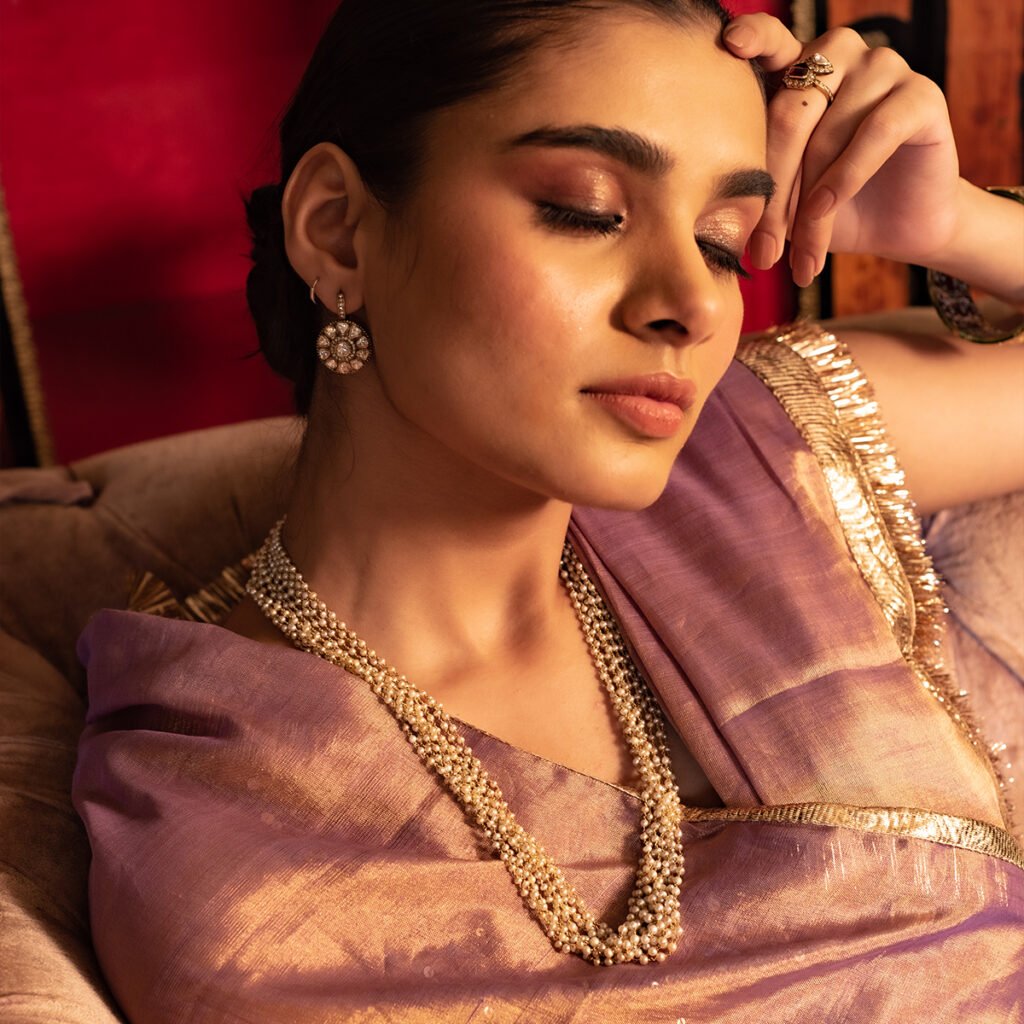 Sutra Fine Jewellery campaign: model in a mauve saree with a layered gold chain