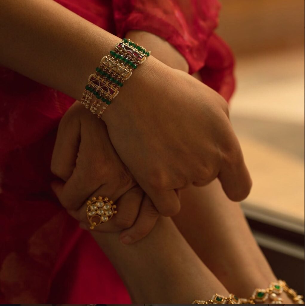 Vamika Silver jadau bracelet and ring on clasped hands